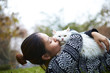 © Bo Bo/Stocksy - happy young asian woman with her cat outdoor