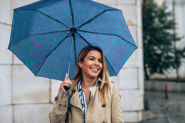 Sticker - beautiful woman enjoying a walk on a rainy day.