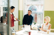 © Aila Images/Stocksy - Business meeting at work at trendy startup company presenting pitch for growth and development