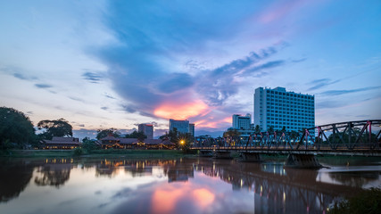 Wall Mural - The historical iron bridge at Chiangmai city skyline at Ping river at dusk. Chiangmai , Thaland. Long exposure photograph.