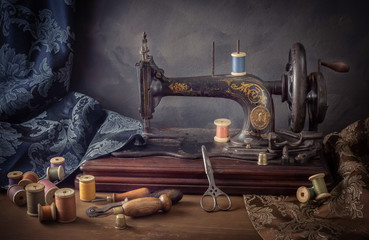 Still life with a sewing machine, scissors, threads