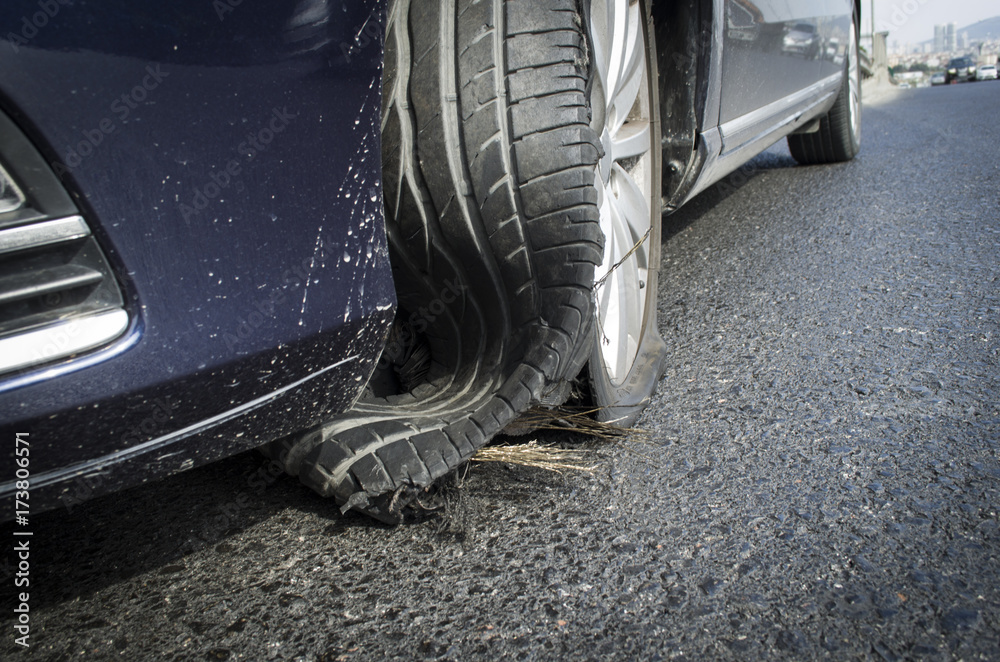 damaged tire after tire explosion at high speed on highway - obrazy, fototapety, plakaty 