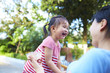 © Bo Bo/Stocksy - happy little asian girl eating ice cream with her mother in the yard