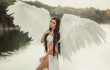 © kharchenkoirina - A beautiful white archangel descended from heaven. A girl in a sexy suit with huge white wings. Artistic Photography