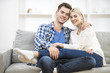 © realstock1 - The happy man and woman sit on the sofa