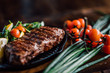 © Boris Jovanovic/Stocksy - Close up of a steak and vegies on the wooden table indoor