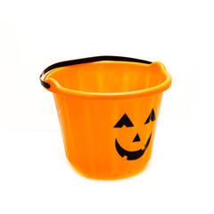 Studio shot Jack O' Lantern Halloween candy bucket isolated on white background. Orange plastic Trick Or Treat candy pail.