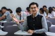 © THANANIT - Portrait of Asian teacher in the classroom, University education concept