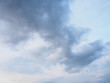 Wide angle view of sunny blue evening sky with dark, rainy, stratocumulus clouds. Cloudscapes and backgrounds concept.