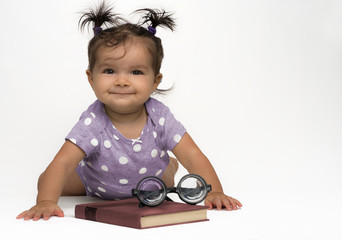 Wall Mural - Mixed race, baby girl in purple, polka dots with book and glasses