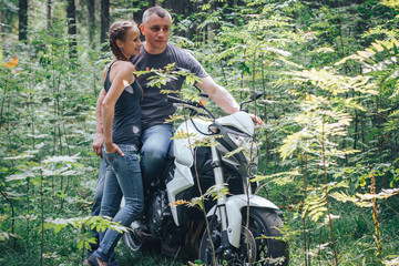 Wall Mural - The motorcyclist and the girl in the forest