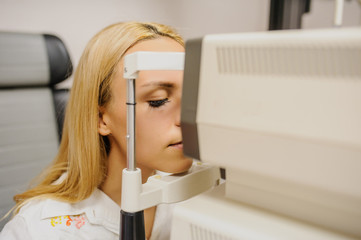 Wall Mural - close up head of young patient fix in a non-mydriatic retinal camera