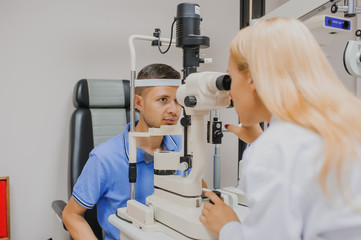 Wall Mural - Young beautiful woman doctor/eye specialist/optometrist in an ophthalmologic clinic