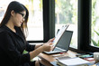 © 88studio - businesswoman plan new business project at workplace. woman analyze market data report at office. finance analyst work with financial graph & chart diagram document.