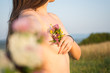 © Catalin Pop - Naked girl outside holding flowers