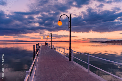 sunset over the transylvania lake in Umbria Italy intense late summer colors in the pier