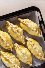 preparation of Delicious homemade Cornish pasties with beef, carrot, and potato.