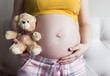 © julya1311 - Belly of a pregnant woman with toy bear
