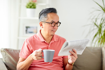 Sticker - man drinking coffee and reading newspaper at home