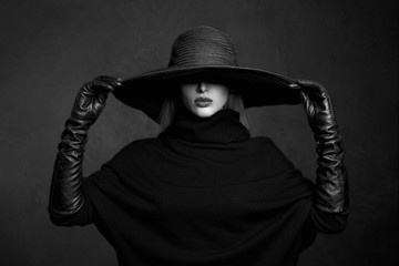 Beautiful woman in hat and leather gloves.fashion model girl.halloween witch