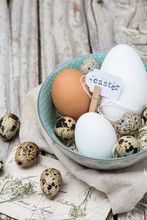 Easter Eggs In A Bowl On Rustic Wood Surface