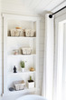 © Trinette Reed/Stocksy - Shelving in rustic farmhouse bathroom