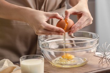 Canvas Print - Female chef making dough in glass bowl on kitchen table