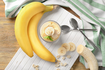 Wall Mural - Glass with delicious banana pudding on wooden board