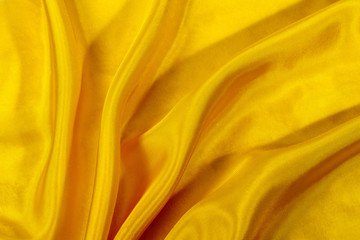silk background, texture of yellow shiny fabric