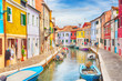 Colorful houses with boats in Burano island with cloudy blue sky near Venice, Italy. Popular and famous tourist place.