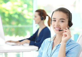 Canvas Print - Young female technical support dispatcher working in office