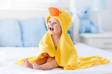 Cute baby after bath in yellow duck towel