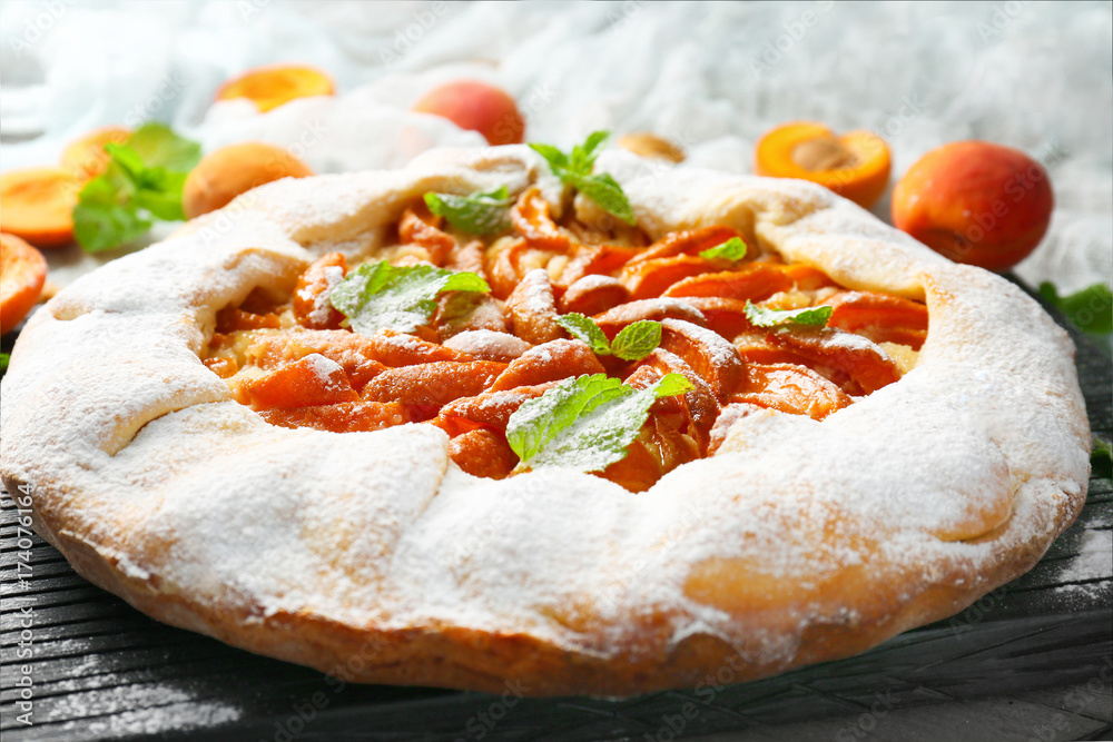 Delicious apricot cake on table, close up