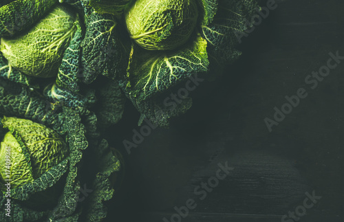 Raw fresh uncooked green cabbage over dark background, top view, selective focus Poster Mural XXL
