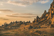 Natural volcanic rocks with ancient cave houses in Goreme in Cappadocia, Central Anatolia region of Turkey, at sunset on clear day