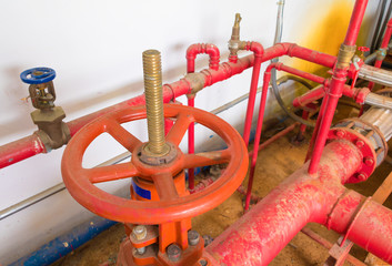 water valve pipe system Old big plumbing  red which has dust dirty inside of building industrial