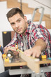 © Atelier 211 - Man working on wood planks for home-improvement