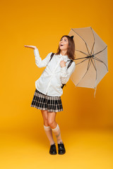 Wall Mural - Full length portrait of a happy schoolgirl in uniform