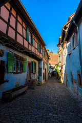 Wall Mural - Beautiful village Riquewihr with historic buildings and colorful houses in Alsace of France - Famous vine route