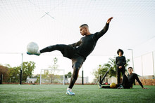 Man Kicking Soccer Ball On Field