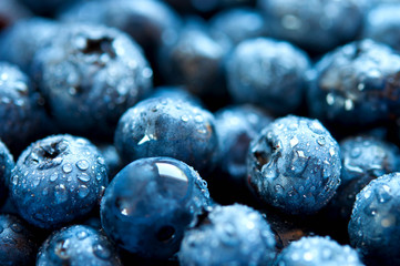 Background of blueberries in water drops.