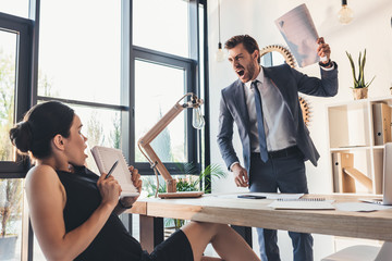 Businessman reprehending secretery