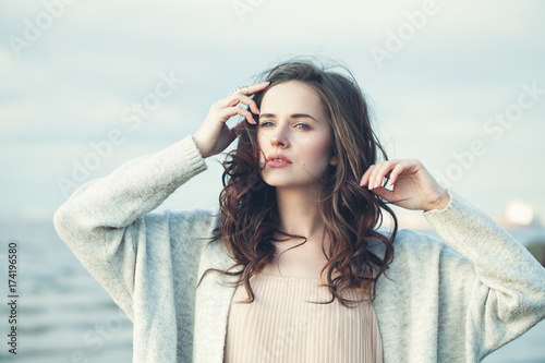 Fotomural Portrait of a Beautiful Girl with Curly Hair on a Cold Windy Day Outdoors