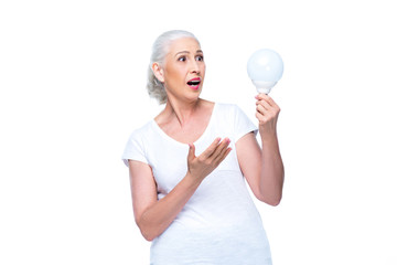 Canvas Print - senior woman with light bulb