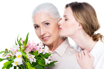 Wall Mural - adult daughter kissing her mother