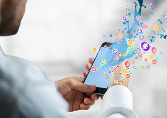 Poster - hands with phone with application icons coming up from it.