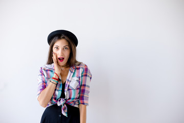 Wall Mural - Surprised woman touches cheeks with right hand 