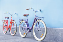 Stylish New Bicycles Near Color Wall Outdoors