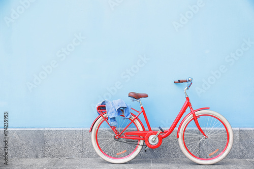 Stylish new bicycle near color wall outdoors © Africa Studio