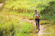 © lifepic - Young woman running at forest trail. Healthy young warming up outdoors.hi key.